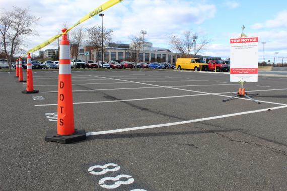 Reserved parking spaces with tow notice sign.