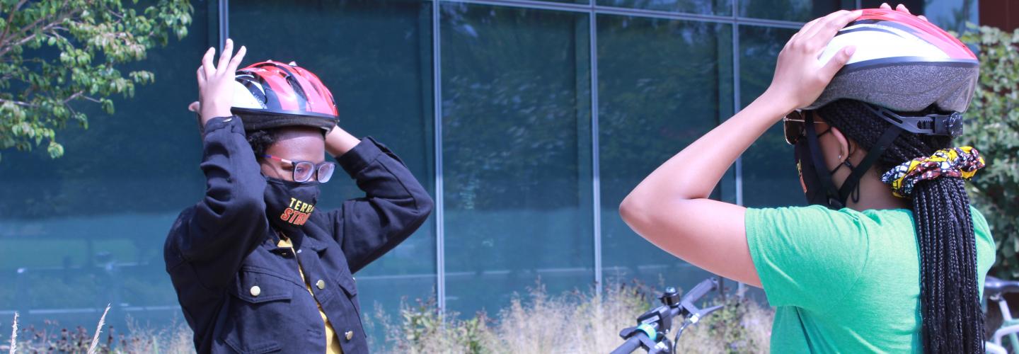 Students putting on helmets